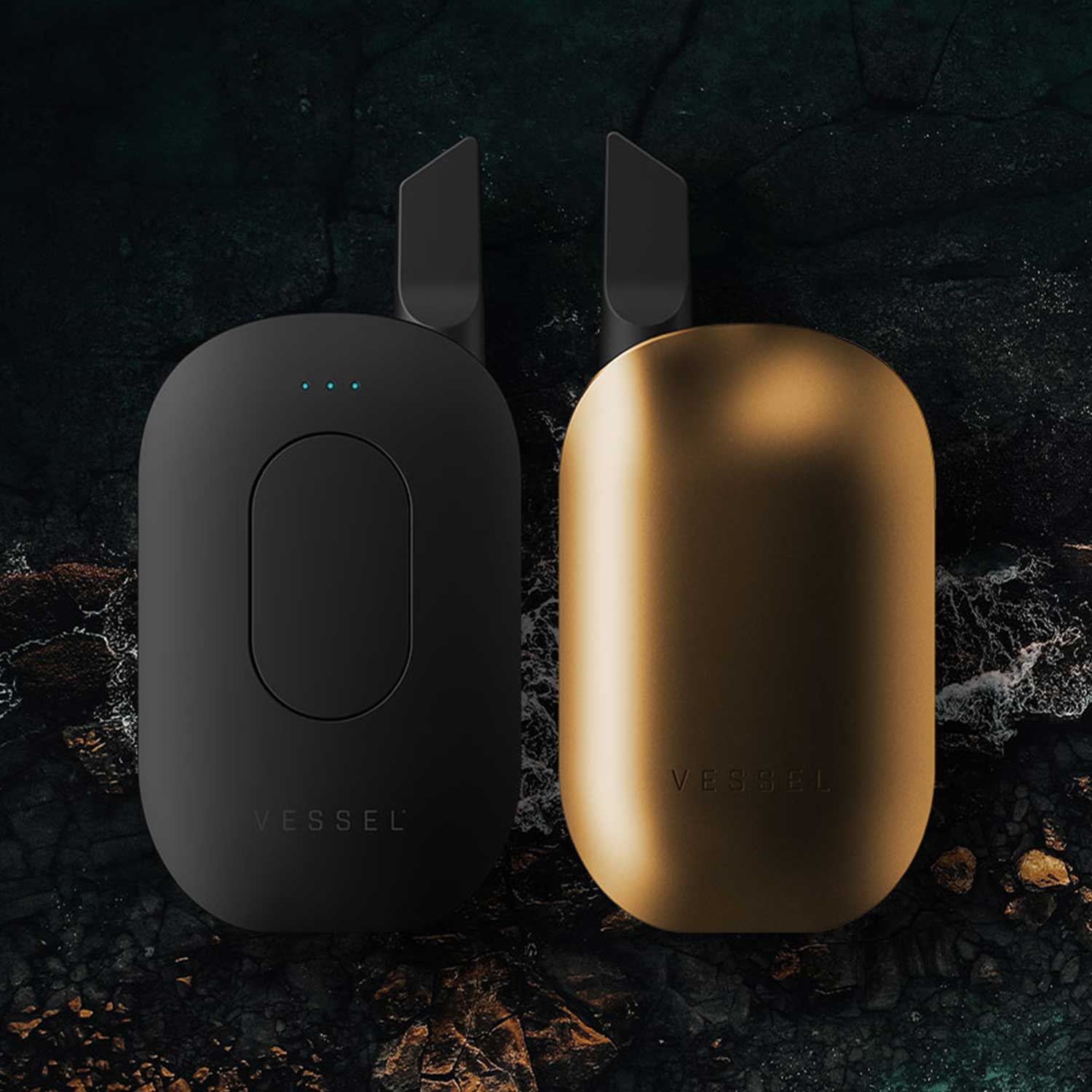 Vessel Compass 510 thread palm style batteries in matte black and Gold with cartridges on dark textured background