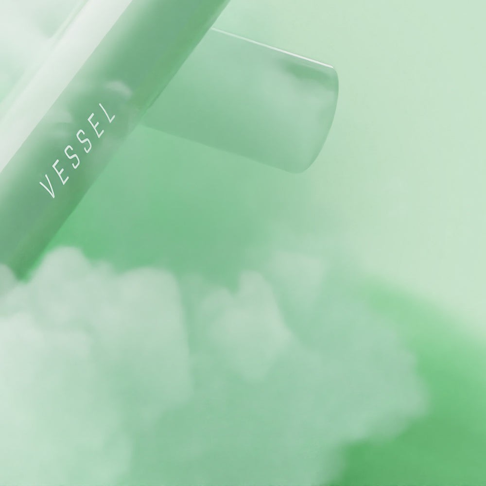 Close-up of Vessel Jade Air glass one hitter showcasing translucent jade green glass with minimalist aesthetic
