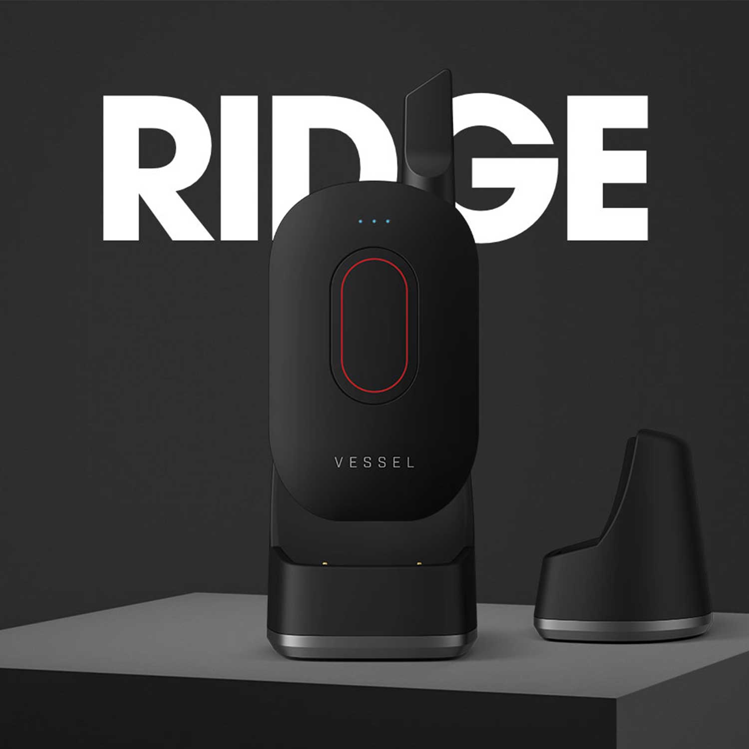 Matte black Vessel Compass with red accent in Ridge magnetic base charger with cartridge accessory against backdrop featuring large RIDGE text